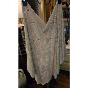 Vintage crocheted lace tablecloth with intricate openwork patterns.